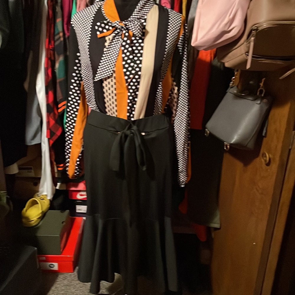 2 pieces. Skirt with ruffles on the bottom wit Blouse.